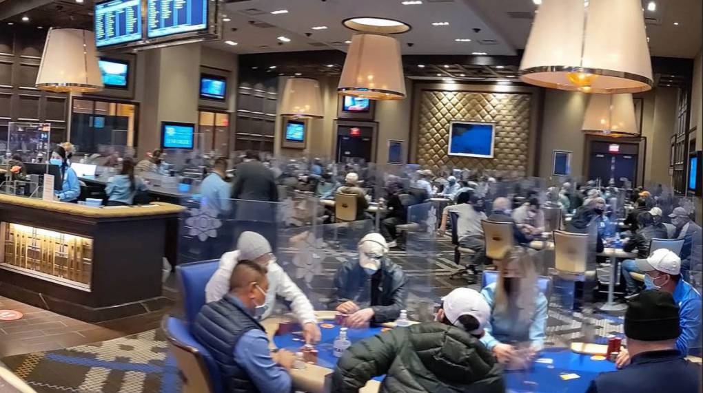 crowded poker rooom with full tables