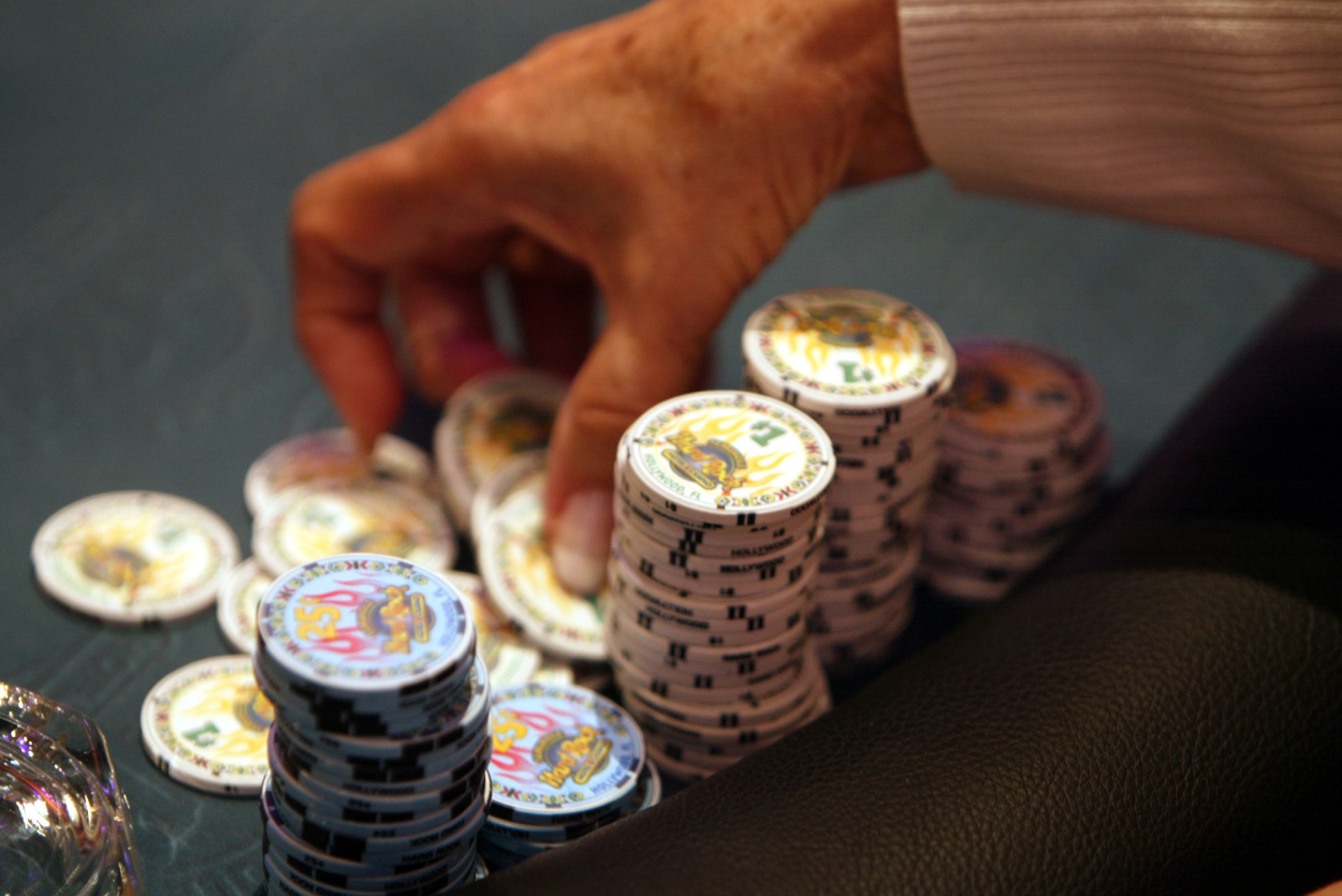 A poker player prepares to throw some chips into the pot