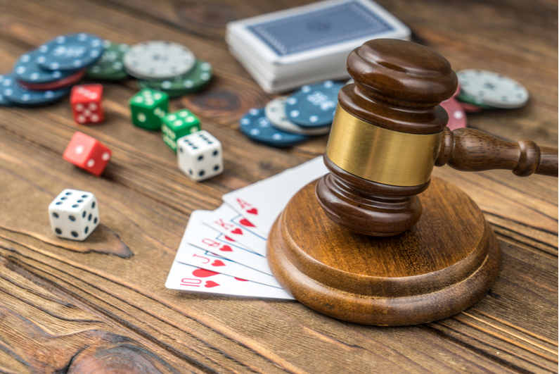 Judge's gavel with dice, chips, and cards